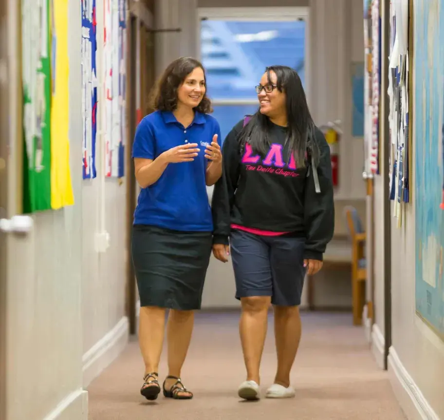 Sociology student walking with advisor