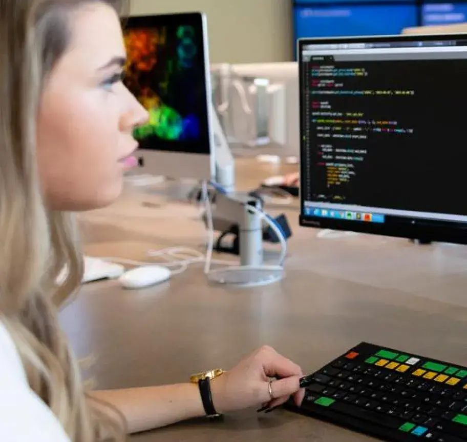 A woman studies code on a computer