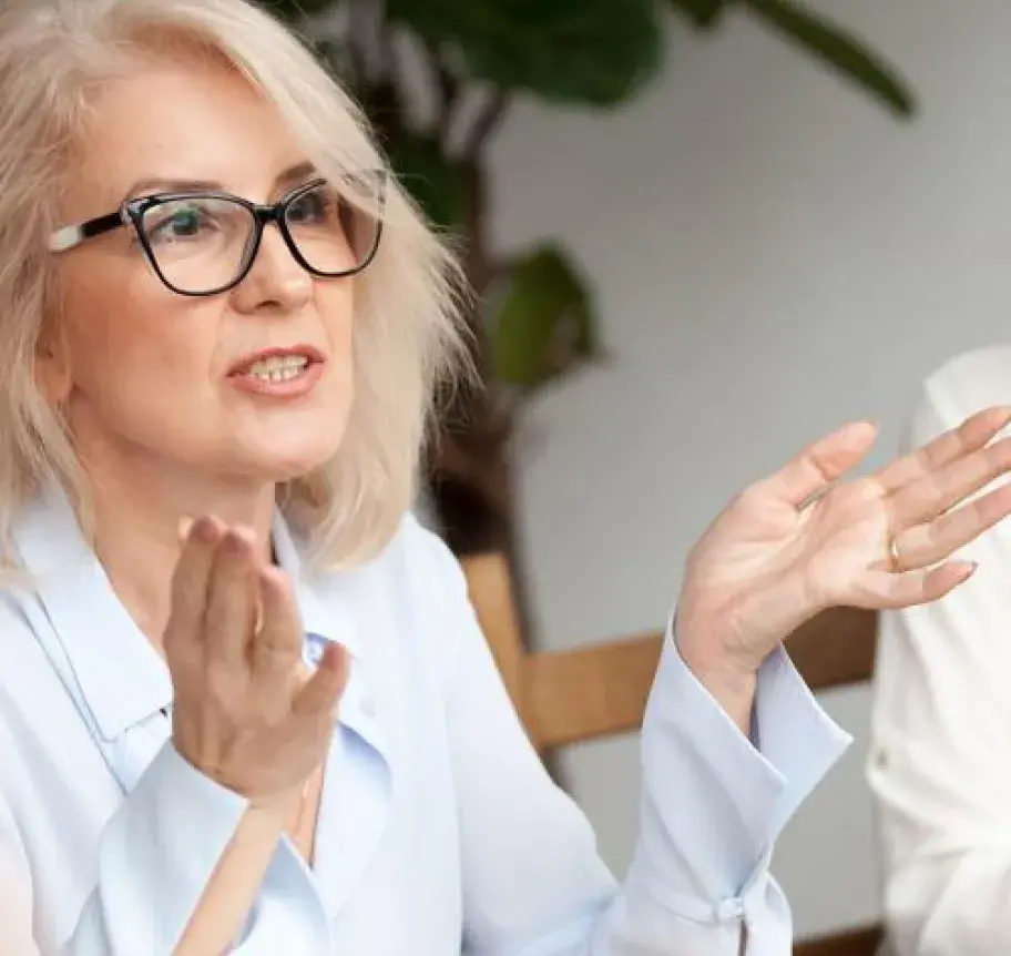 A woman speaking while gesturing with her hands