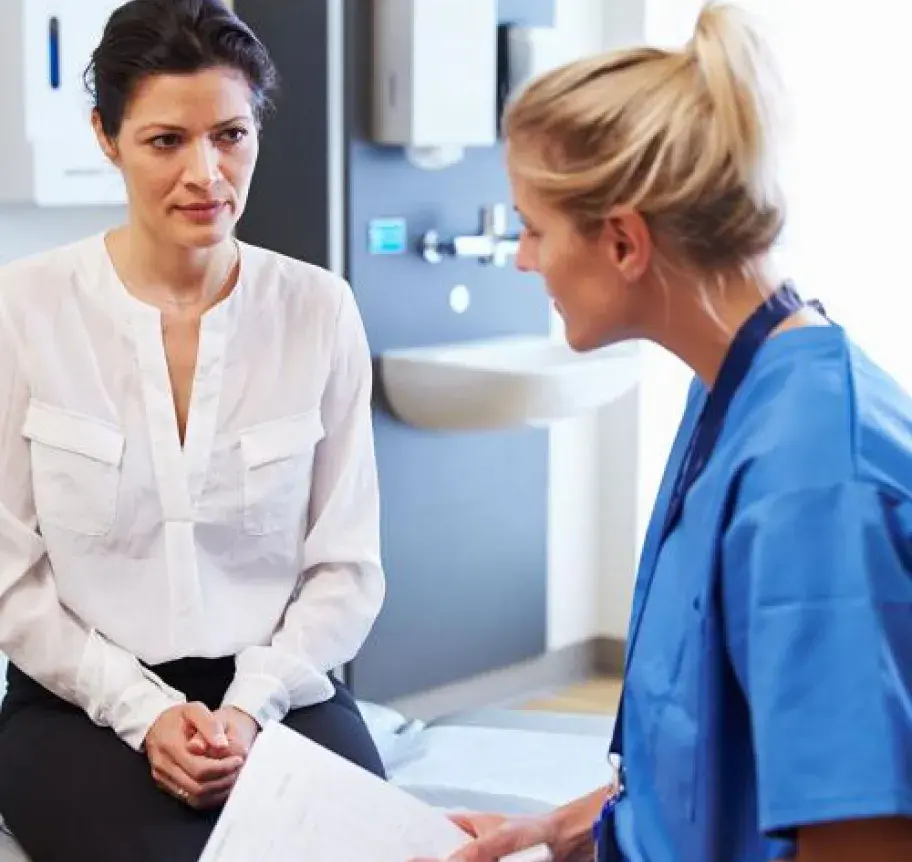 A health care professional speaks to a patient