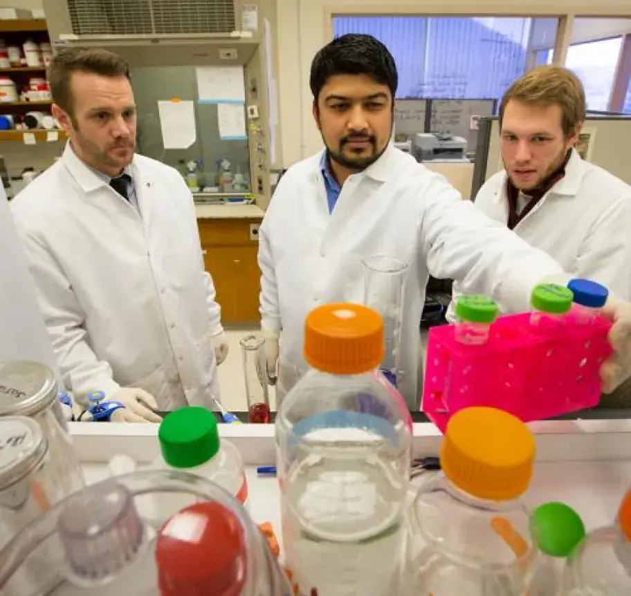Three students working in a lab