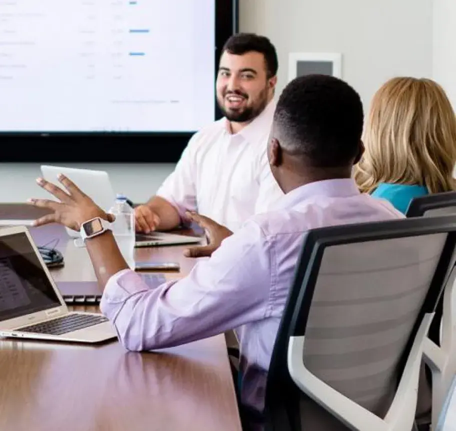 A group of business professionals sitting in a conference room having a meeting