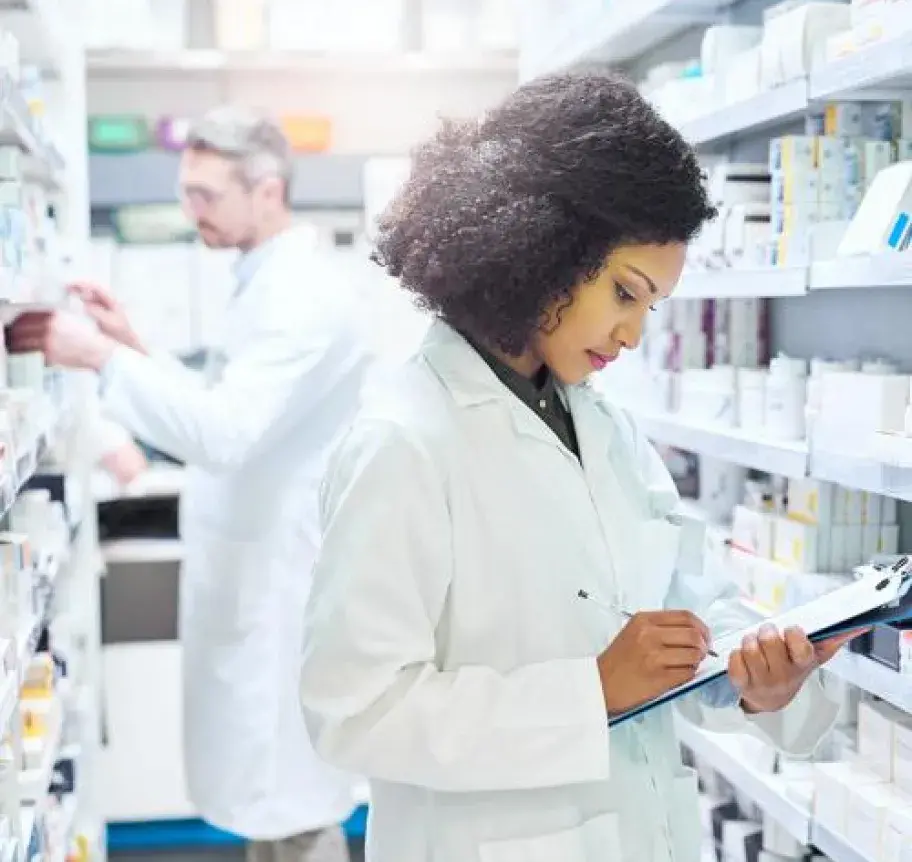 Two pharmacologists checking medication