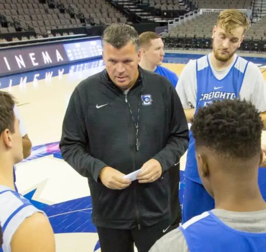 A basketball coach talking to a group of players