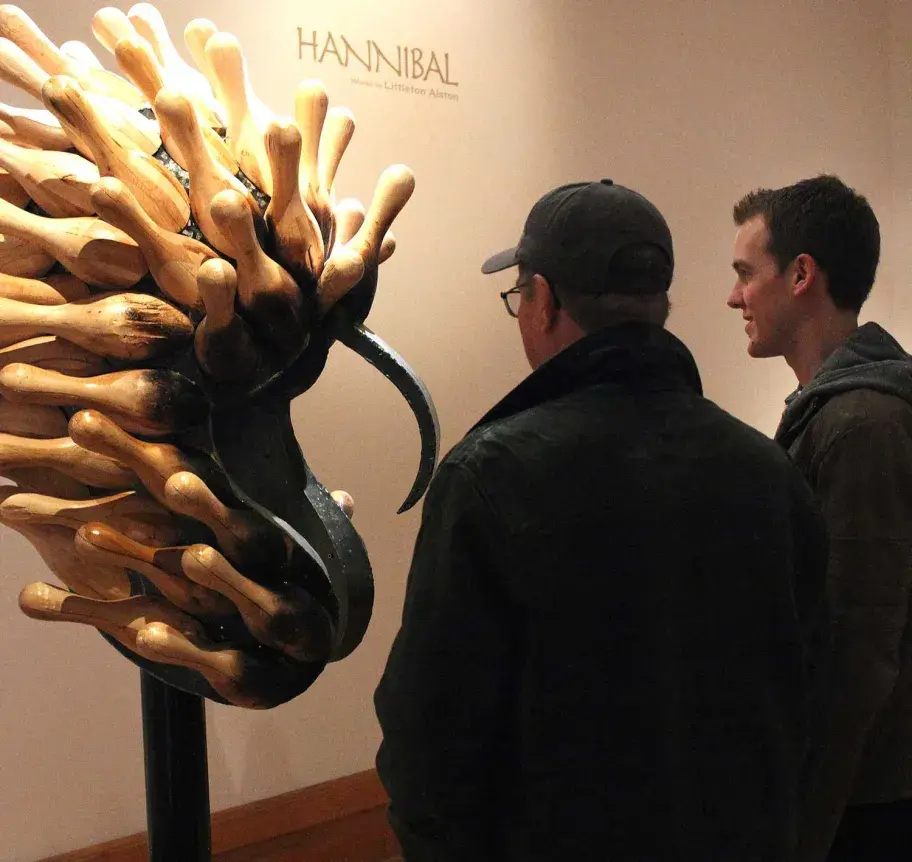 Student and parent viewing sculpture
