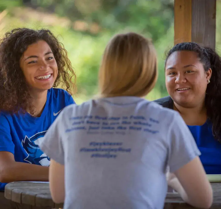 Students collaborating outdoors on Creighton campus