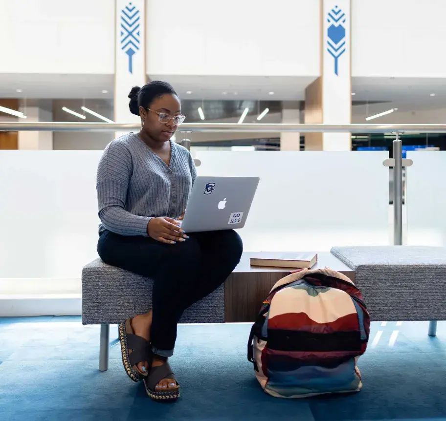 Student working on laptop in Harper Center