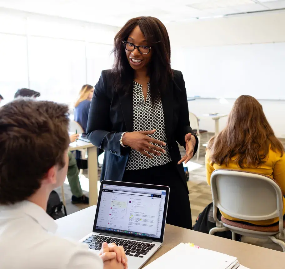 Business faculty working with students in the classroom