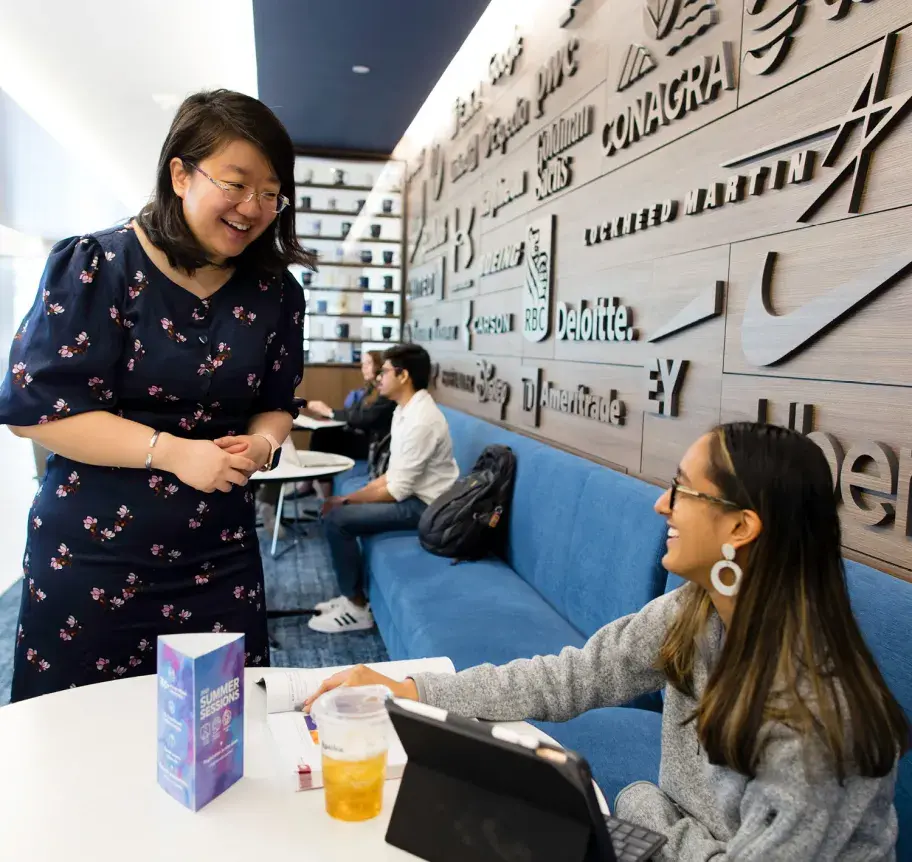Business faculty engaged with student in Harper Center