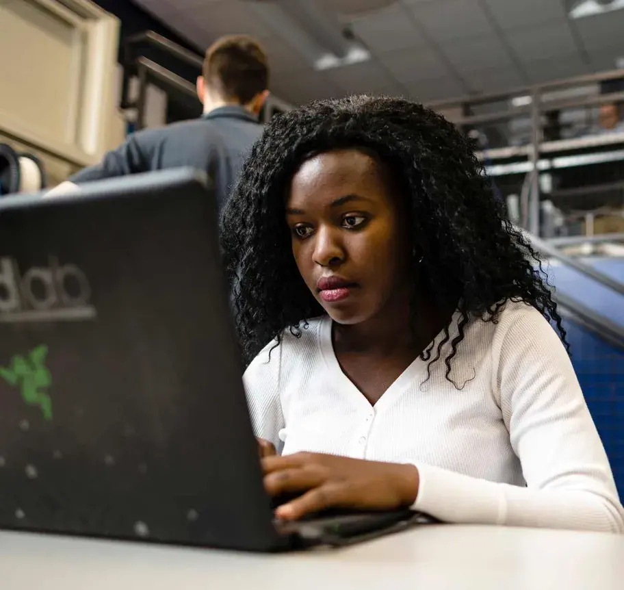 Computer science student working at laptop