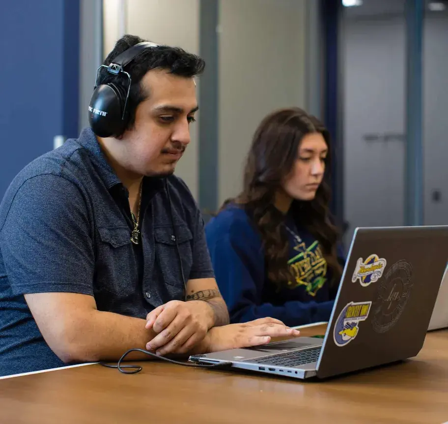 Computer science students working at laptops