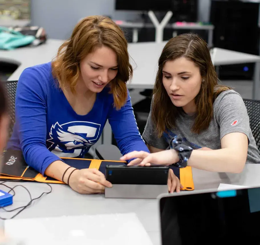 Students working together on device