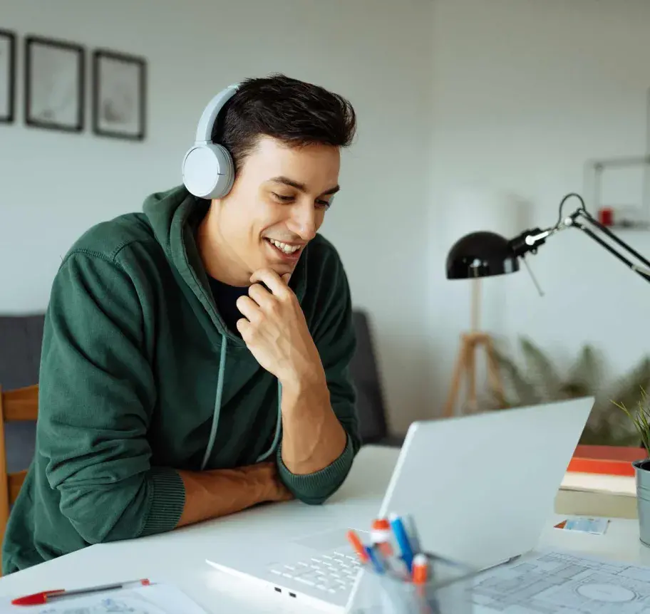 Student attending classes online at laptop