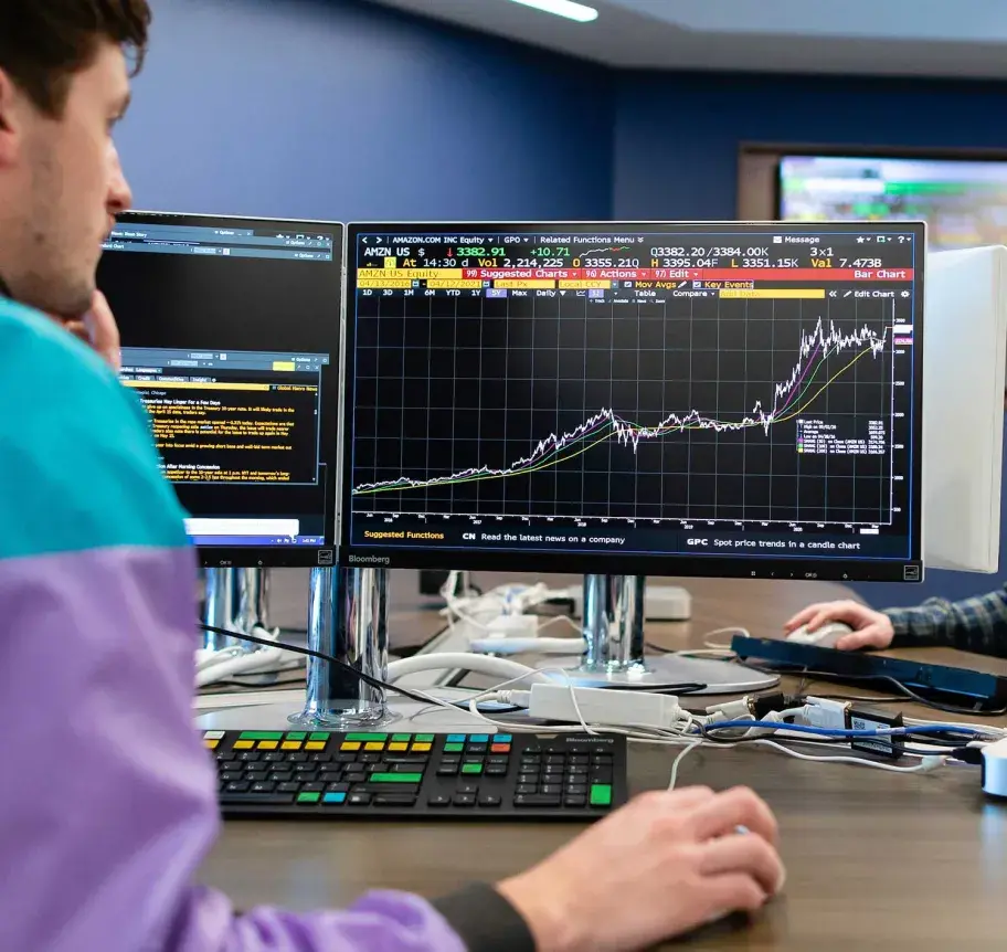 Finance student working on computer in finance software