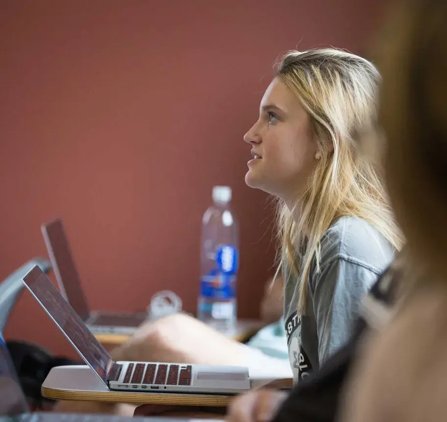 Student in classroom using laptop