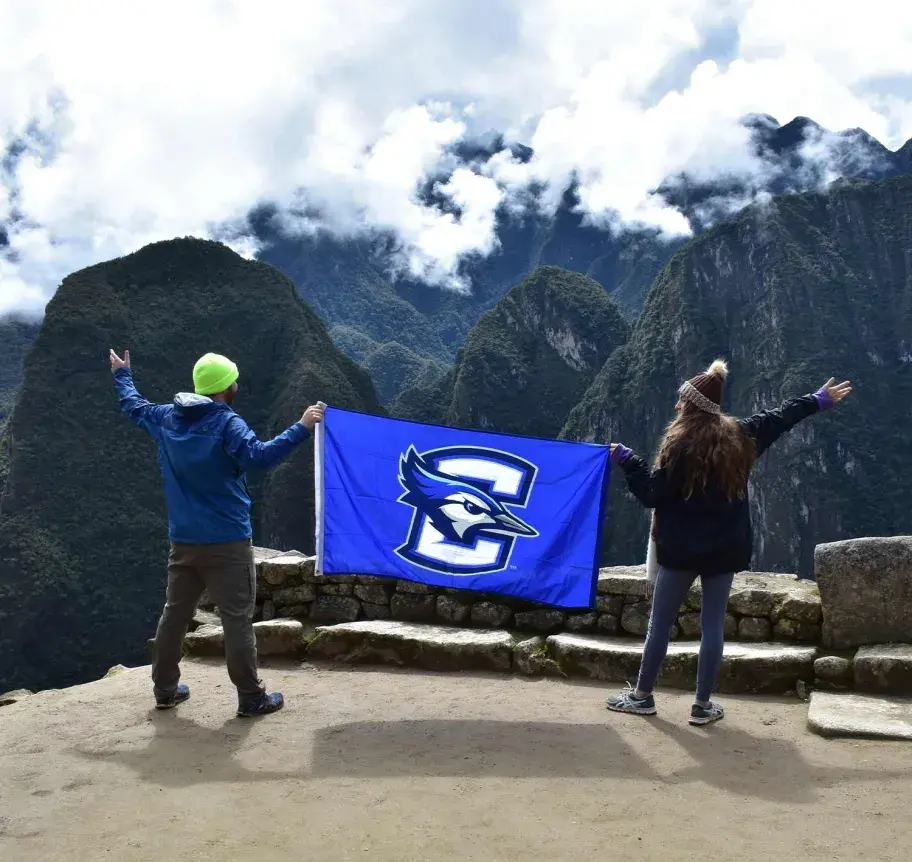 Creighton students holding flag while studying abroard