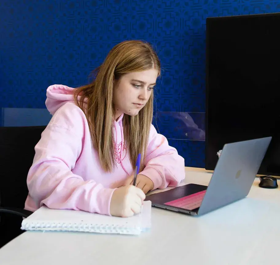 Student at laptop taking notes