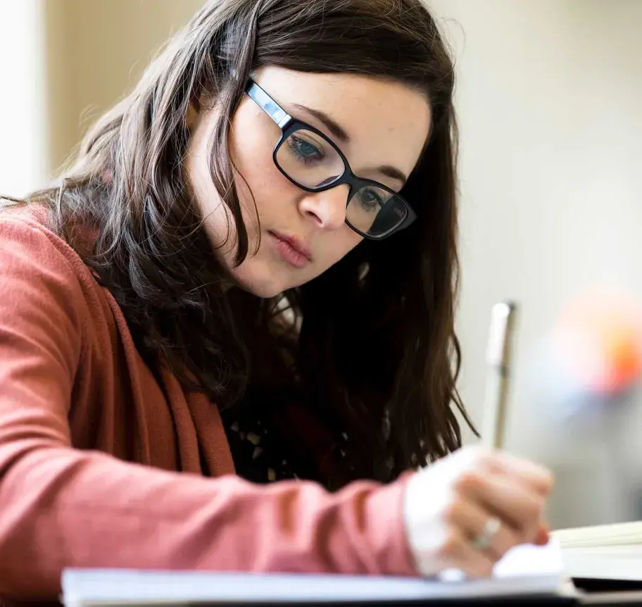 Student writing notes on paper