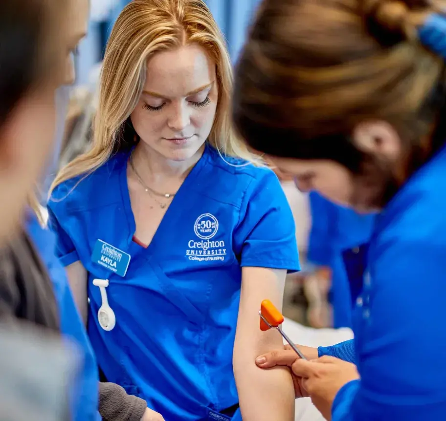 Nursing students testing reflexes on other students