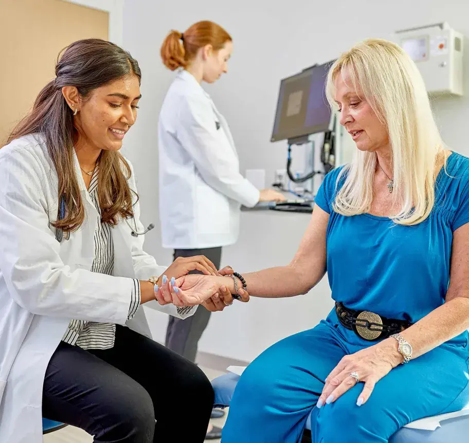 Faculty supervising physician assistant student assessing patient