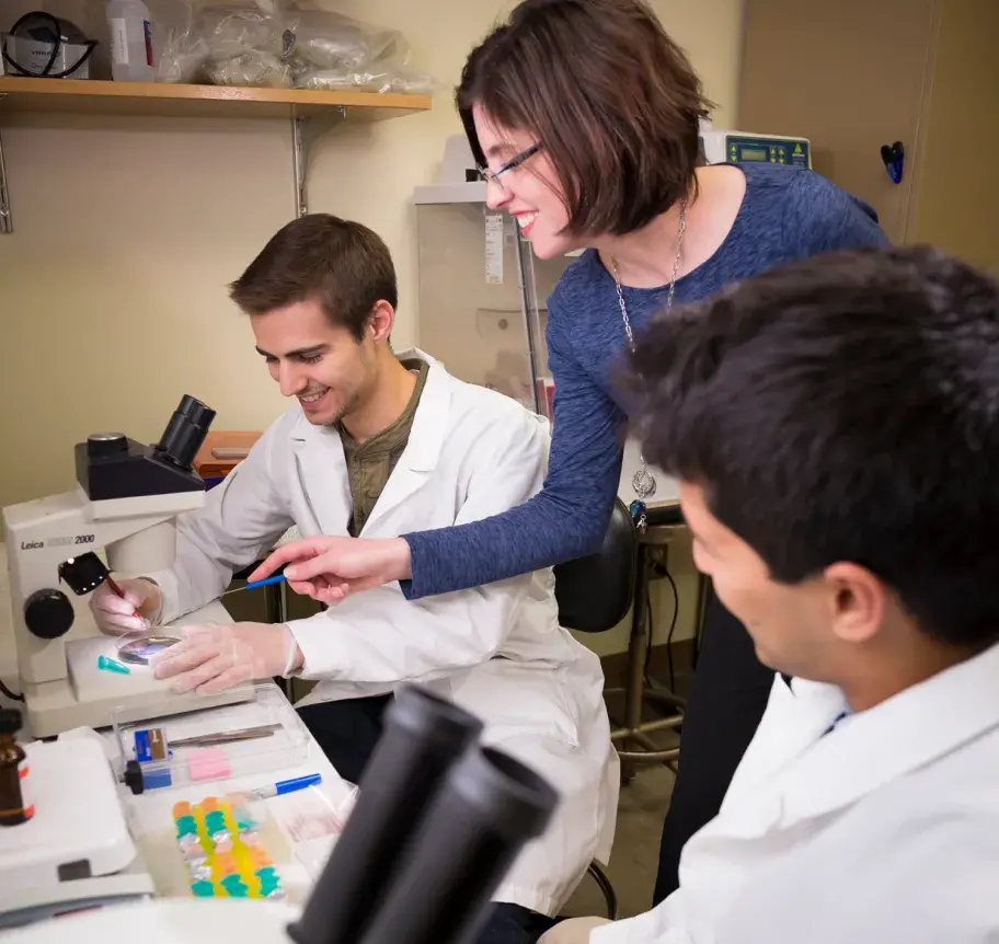 Creighton students with faculty in science lab