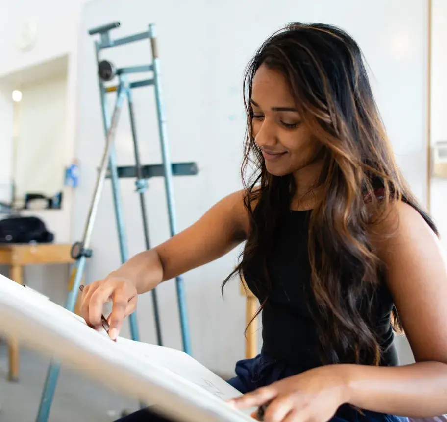 Art studio student working on a pencil drawing