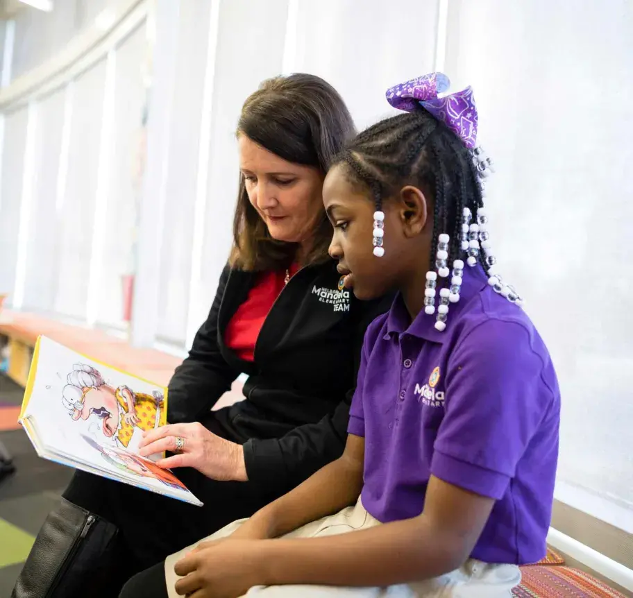Elementary teacher working with student