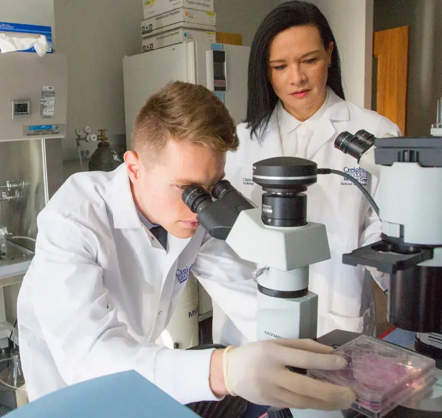 Dental student working with faculty in dentistry lab