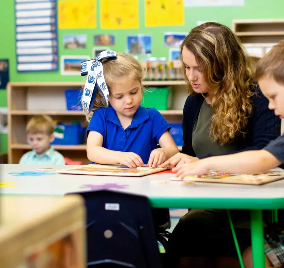 Teacher interacting with young students in the classroom