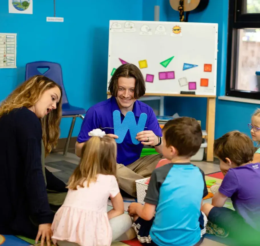 Teachers presenting the alphabet to young children 