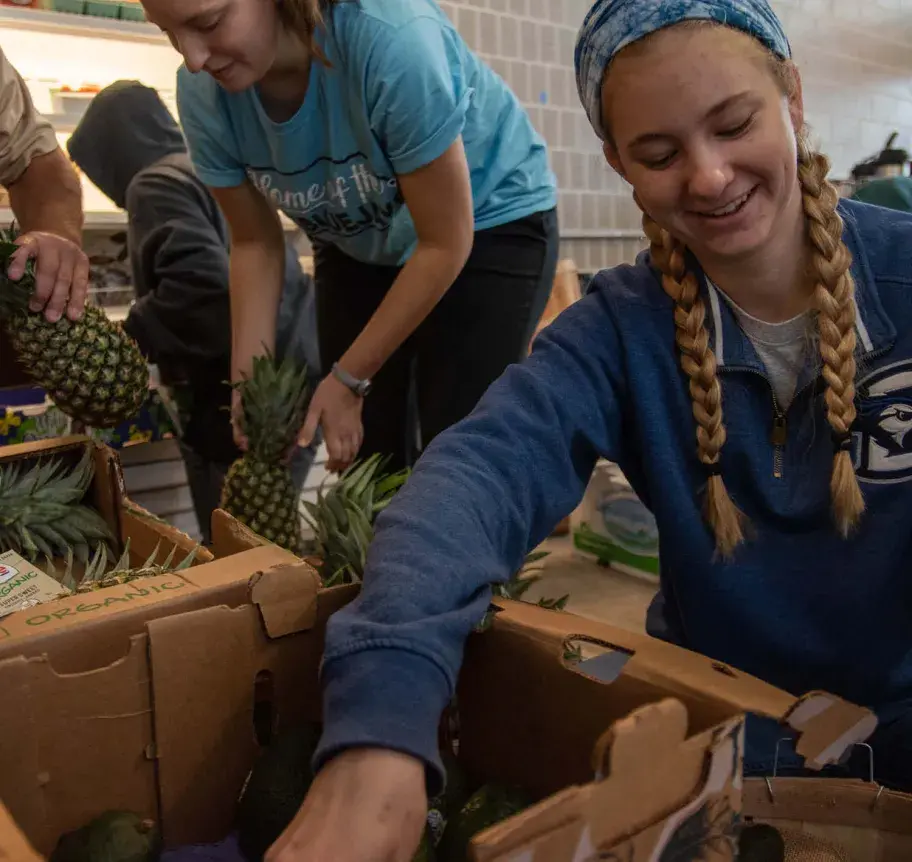 Students organizing boxes of fresh food donations