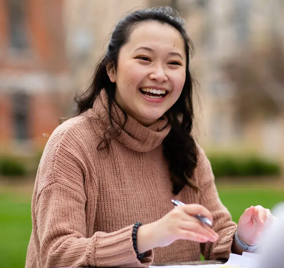 Creighton student sitting outdoors on campus