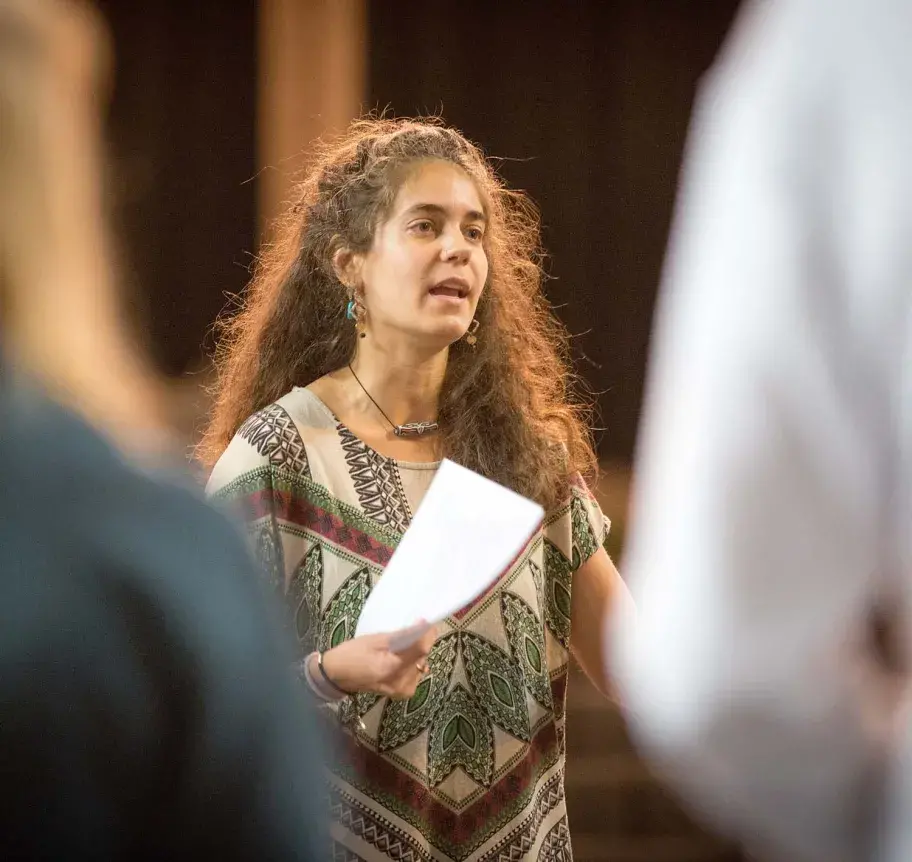Theatre faculty instructing students on stage