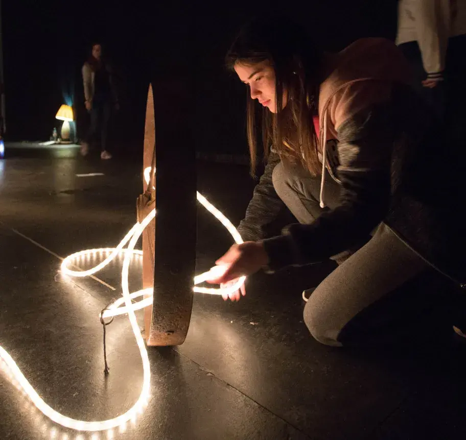 Theatre student setting up lights on stage