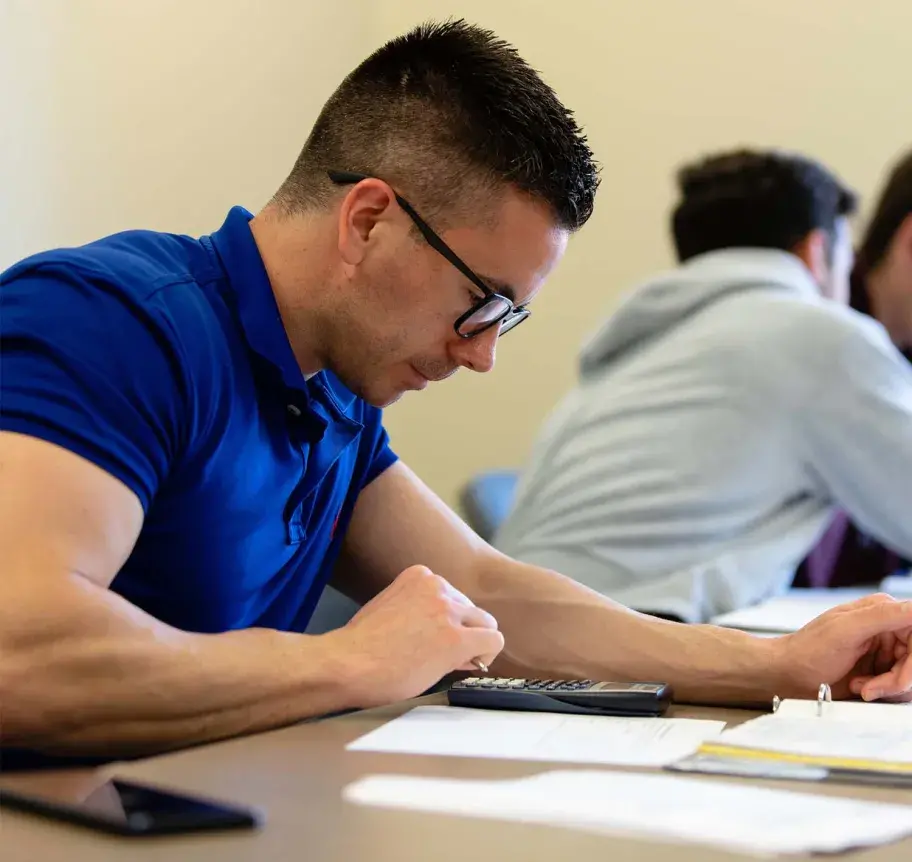 Finance student using calculator