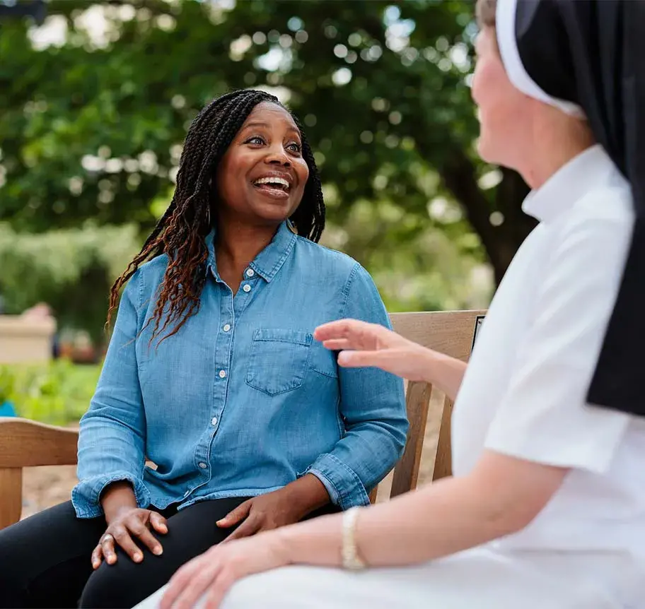 Spiritual Direction student and faculty sitting on bench