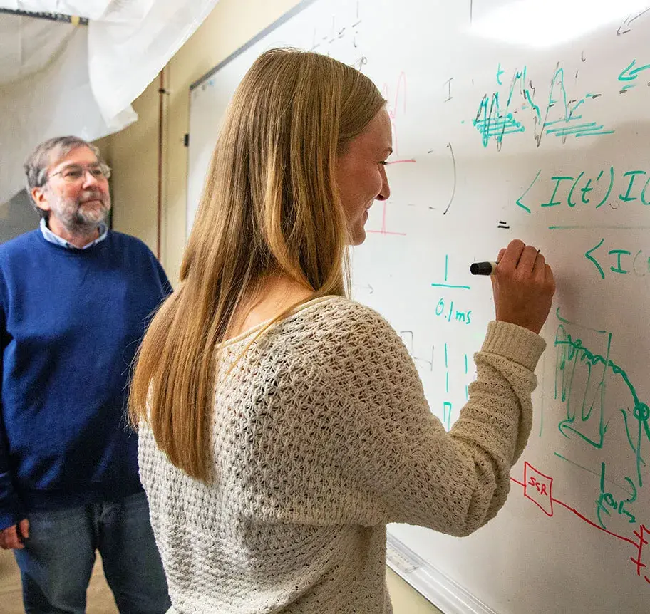 Physics student at white board