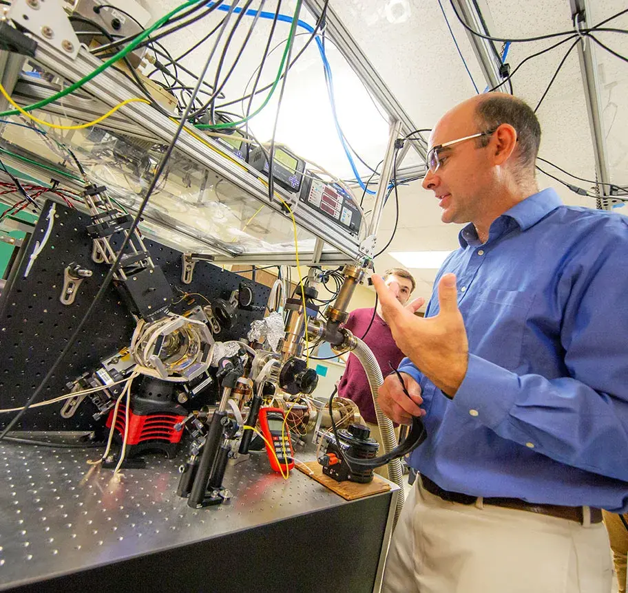 Physics faculty instructing in lab