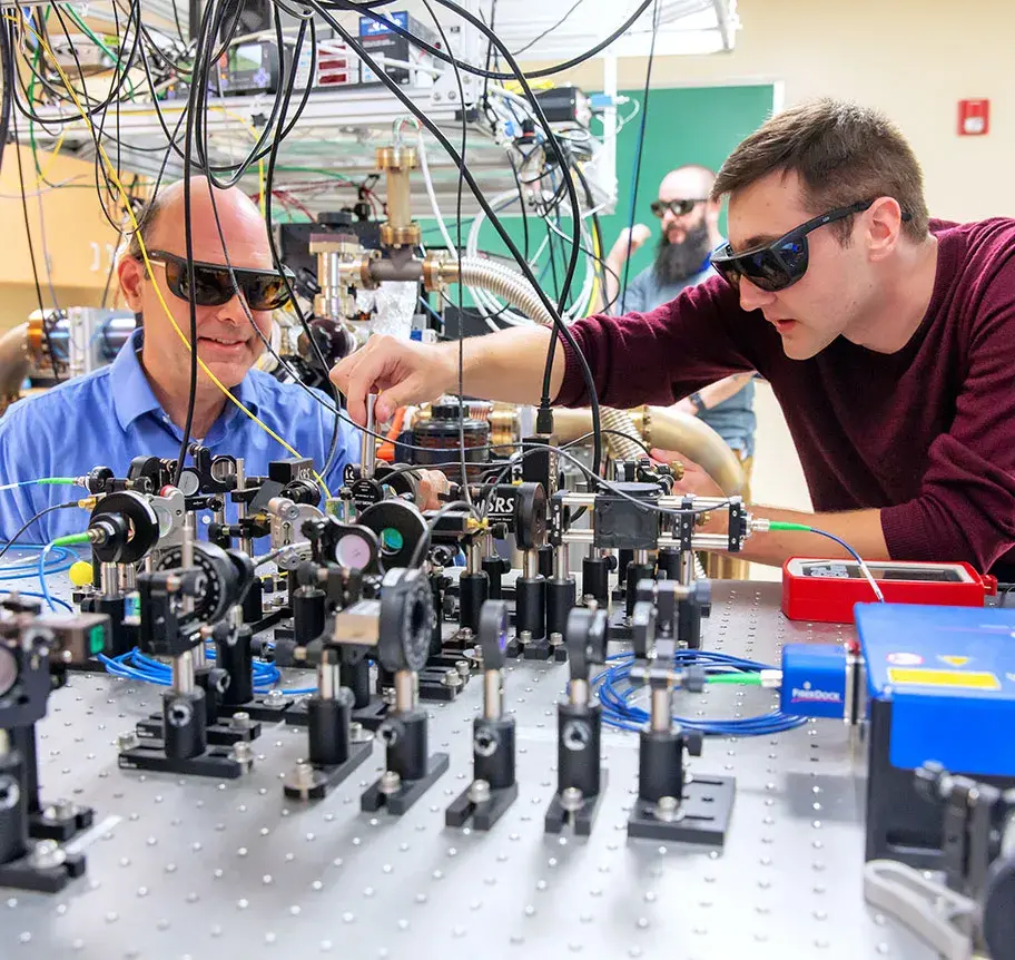Student and faculty in physics lab