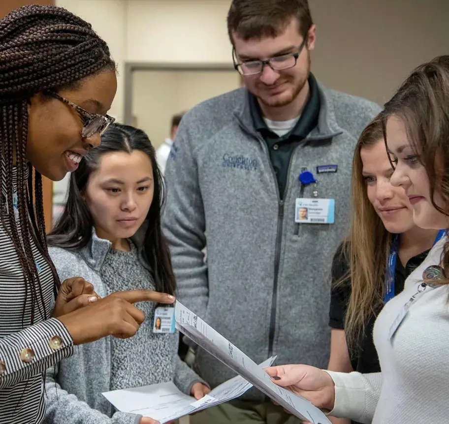 Faculty and students reviewing work