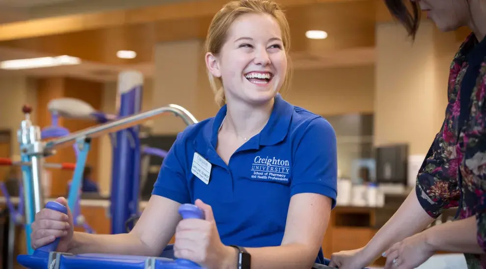physical therapy student practicing with equipment