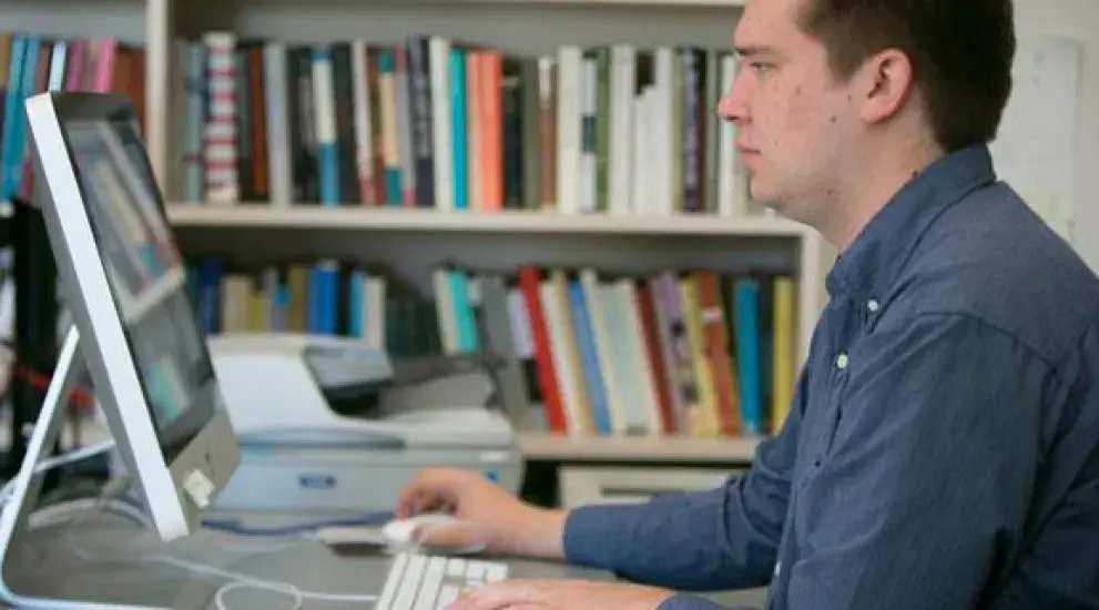 A male instructor using a computer