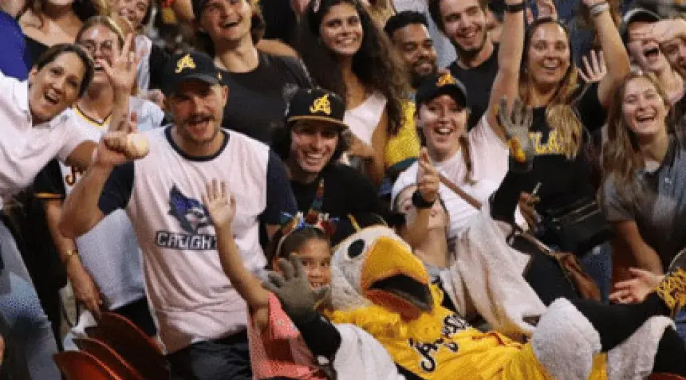 Students at a Las Aguilas Cibaenas baseball game