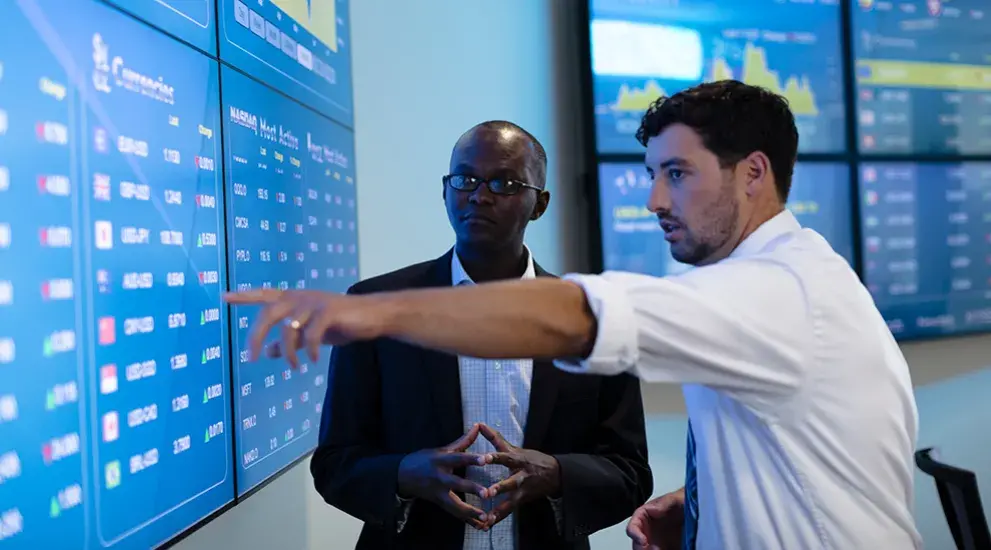 Student and faculty in Creighton's investment center