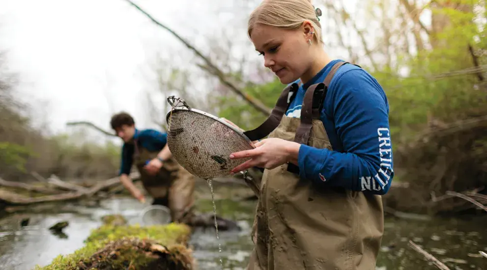 Students doing field work in a wetland environment.