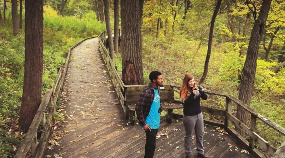 Fontenelle Forest in Omaha area with two people on wooded trail.