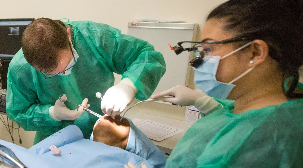 Dental surgery wearing scrubs in the operating room