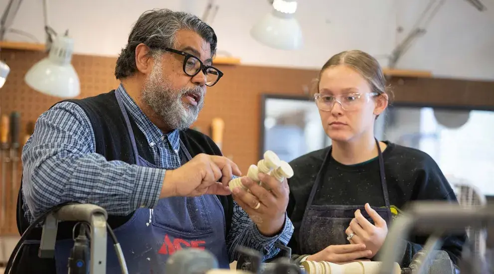 Faculty Littleton Alston working with student in fine arts