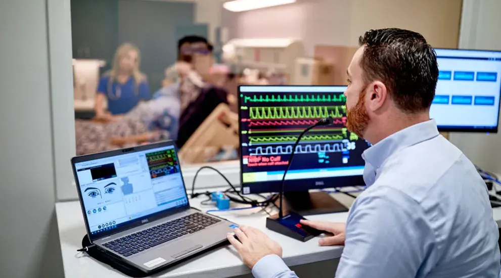 Man working and monitoring in testing center with computer equipment.