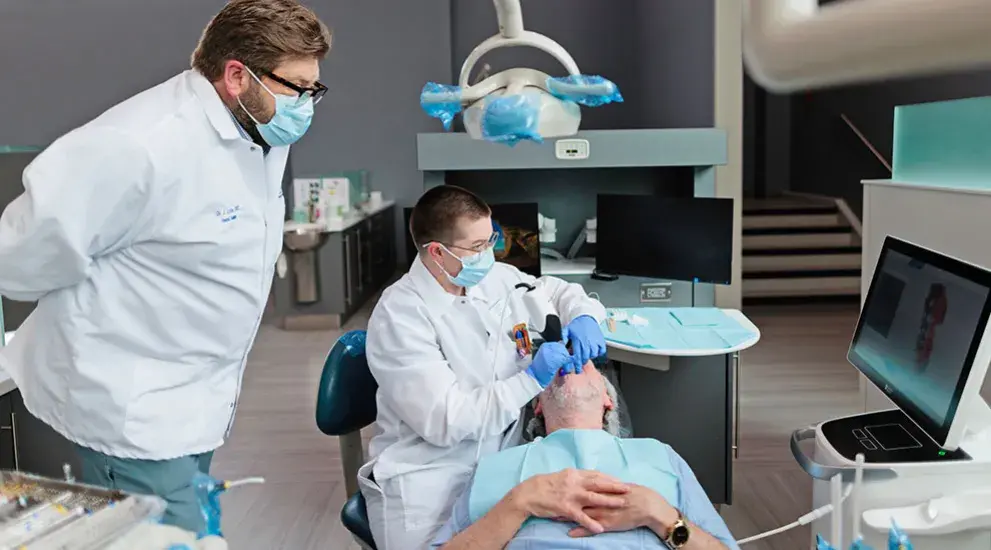 Dental student being helped by professor